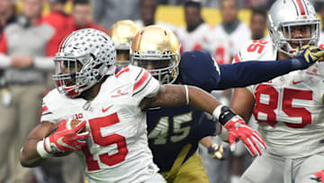 GLENDALE, AZ - JANUARY 01: Ezekiel Elliott #15 of the Ohio State Buckeyes runs with the ball as Romeo Okwara #45 of the Notre Dame Fighting Irish attempts to make a tackle during the BattleFrog Fiesta Bowl at the University of Phoenix Stadium on January 1, 2016 in Glendale, Arizona. Buckeyes won 44-28. (Photo by Norm Hall/Getty Images)