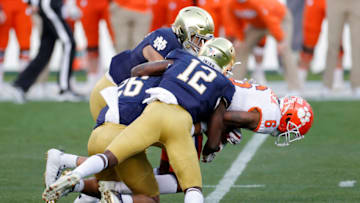 CHARLOTTE, NORTH CAROLINA - DECEMBER 19: Wide receiver E.J. Williams #6 of the Clemson Tigers is tackled by safety DJ Brown #12 of the Notre Dame Fighting Irish in the first half during the ACC Championship game at Bank of America Stadium on December 19, 2020 in Charlotte, North Carolina. (Photo by Jared C. Tilton/Getty Images)