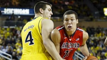 Dec 14, 2013; Ann Arbor, MI, USA; Arizona Wildcats forward Aaron Gordon (11) is defended by Michigan Wolverines forward Mitch McGary (4) in the second half at Crisler Center. Arizona won 72-70. Mandatory Credit: Rick Osentoski-USA TODAY Sports