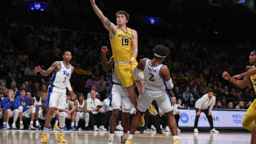 Nov 16, 2022; Brooklyn, New York, USA; Michigan Wolverines guard Joey Baker (15) drives to the basket againstPittsburgh Panthers forward Blake Hinson (2) during the first half at Barclays Center. Mandatory Credit: Vincent Carchietta-USA TODAY Sports