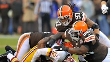 Dec 16, 2012; Cleveland, OH, USA; Cleveland Browns defensive end Jabaal Sheard (97) and defensive tackle Phillip Taylor (98) sack Washington Redskins quarterback Kirk Cousins (12) at Cleveland Browns Stadium. Washington won 38-21. Mandatory Credit: David Richard-USA TODAY Sports