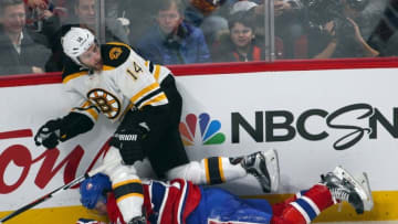 Dec 9, 2015; Montreal, Quebec, CAN; Montreal Canadiens defenseman Alexei Emelin (74) falls on ice after battling for the puck with Boston Bruins right wing Brett Connolly (14) during the second period at Bell Centre. Mandatory Credit: Jean-Yves Ahern-USA TODAY Sports