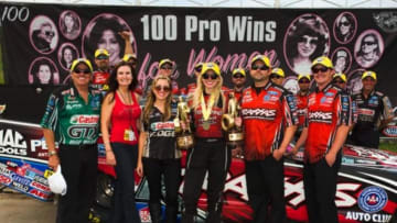 May 25, 2014; Topeka, KS, USA; NHRA funny car driver Courtney Force (center) celebrates with father John Force , mother Laurie Force and sister Brittany Force after winning the Kansas Nationals at Heartland Park Topeka. With the victory, Force became the 100th pro female win in NHRA history. Mandatory Credit: Jason Zindroski-USA TODAY Sports