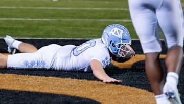Nov 12, 2022; Winston-Salem, North Carolina, USA; North Carolina Tar Heels quarterback Drake Maye (10) dives for a score on a keeper against the Wake Forest Demon Deacons during the second half at Truist Field. Mandatory Credit: Jim Dedmon-USA TODAY Sports