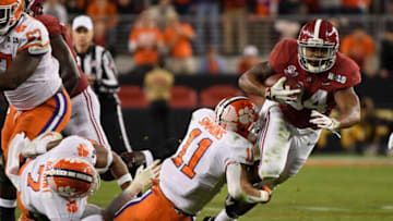 SANTA CLARA, CA - JANUARY 07: Damien Harris #34 of the Alabama Crimson Tide is tackled by Isaiah Simmons #11 of the Clemson Tigers during the second half in the CFP National Championship presented by AT&T at Levi's Stadium on January 7, 2019 in Santa Clara, California. (Photo by Harry How/Getty Images)