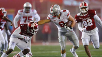 Ohio State Buckeyes tight end Cade Stover (8) gives Indiana Hoosiers defensive back Devon Matthews (1) a stiff arm during the NCAA football game at Memorial Stadium in Bloomington, Ind. on Sunday, Oct. 24, 2021. Ohio State won 54-7.Ohio State Buckeyes At Indiana Hoosiers