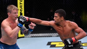 LAS VEGAS, NEVADA - AUGUST 29: (R-L) Alex Caceres punches Austin Springer in their featherweight fight during the UFC Fight Night event at UFC APEX on August 29, 2020 in Las Vegas, Nevada. (Photo by Jeff Bottari/Zuffa LLC)