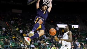 Feb 13, 2023; Waco, Texas, USA; West Virginia Mountaineers forward Tre Mitchell (3) follows thru on a dunk in front of Baylor Bears forward Jonathan Tchamwa Tchatchoua (23) during the first half at Ferrell Center. Mandatory Credit: Raymond Carlin III-USA TODAY Sports