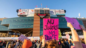 LOUISVILLE, KY - SEPTEMBER 19: Demonstrators gather in protest outside Cardinal Stadium during a game between the Miami Hurricanes and the Louisville Cardinals on September 19, 2020 in Louisville, Kentucky. Demonstrators marched to the stadium, disrupted patron entry and called for justice for Breonna Taylor, who was fatally shot by Louisville Metro police officers during a no-knock raid at her apartment on March 13, 2020. (Photo by Jon Cherry/Getty Images)