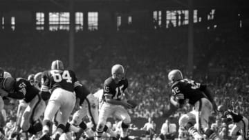 CLEVELAND, OH - SEPTEMBER 16, 1962: Quarterback Jim Ninowski #15 of the Cleveland Browns turns to fake ahandoff to runningback Jim Brown #32 before turning and throwing a screen pass to runningback Ernie Green during a game on September 16, 1962 against the New York Giants at Municpal Stadium in Cleveland, Ohio.19620916-0251962 Kidwiler Collection/Diamond Images