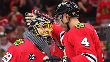 CHICAGO, ILLINOIS - DECEMBER 15: Seth Jones #4 of the Chicago Blackhawks celebrates a win over the Washington Capitals with Marc-Andre Fleury #29 at the United Center on December 15, 2021 in Chicago, Illinois. The Blackhawks defeated the Capitals 5-4 in overtime. (Photo by Jonathan Daniel/Getty Images)