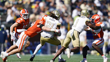 Oct 17, 2020; Atlanta, GA, USA; Georgia Tech Yellow Jackets running back Jahmyr Gibbs (21) is tackled by Clemson Tigers linebacker Baylon Spector (10) at Bobby Dodd Stadium. Mandatory Credit: David Platt via USA TODAY Sports