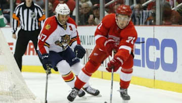 Nov 29, 2015; Detroit, MI, USA; Detroit Red Wings center Dylan Larkin (71) skates with the puck chased by Florida Panthers center Derek MacKenzie (17) in the first period at Joe Louis Arena. Mandatory Credit: Rick Osentoski-USA TODAY Sports