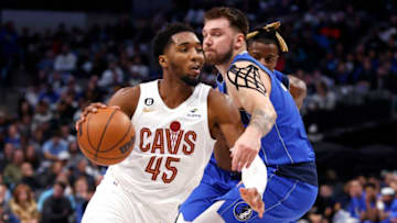 DALLAS, TX - DECEMBER 14: Donovan Mitchell #45 of the Cleveland Cavaliers drives past Luka Doncic #77 of the Dallas Mavericks in the first half at American Airlines Center on December 14, 2022 in Dallas, Texas. NOTE TO USER: User expressly acknowledges and agrees that, by downloading and or using this photograph, User is consenting to the terms and conditions of the Getty Images License Agreement. (Photo by Ron Jenkins/Getty Images)