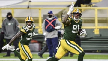 Nov 29, 2020; Green Bay, Wisconsin, USA; Green Bay Packers linebacker Preston Smith (91) returns a Chicago Bears fumble for a touchdown in the second quarter at Lambeau Field. Mandatory Credit: Benny Sieu-USA TODAY Sports