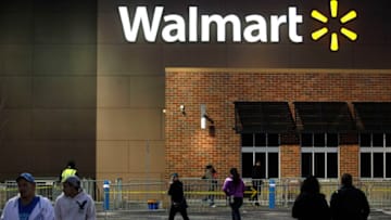 TROY, MI - NOVEMBER 28: Customers walk outside Wal-Mart Thanksgiving day on November 28, 2013 in Troy, Michigan. Black Friday shopping began early this year with most major retailers opening their doors on Thanksgiving day as consumers took advantage of discounted prices to prepare for the holiday season. (Photo by Joshua Lott/Getty Images)