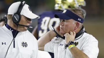 SOUTH BEND, IN - OCTOBER 21: Head coach Brian Kelly of Notre Dame Fighting Irish talks to an assistant coach in the third quarter of a game against the USC Trojans at Notre Dame Stadium on October 21, 2017 in South Bend, Indiana. Notre Dame won 49-14. (Photo by Joe Robbins/Getty Images)