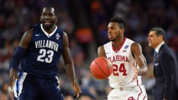 Apr 2, 2016; Houston, TX, USA; Oklahoma Sooners guard Buddy Hield (24) handles the ball against Villanova Wildcats forward Daniel Ochefu (23) during the first half in the 2016 NCAA Men