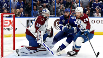 TAMPA, FLORIDA - JUNE 22: Darcy Kuemper #35 and Nathan MacKinnon #29 of the Colorado Avalanche defend against Nicholas Paul #20 of the Tampa Bay Lightning during the first period in Game Four of the 2022 NHL Stanley Cup Final at Amalie Arena on June 22, 2022 in Tampa, Florida. (Photo by Mike Carlson/Getty Images)
