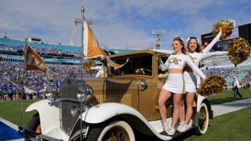 JACKSONVILLE, FL - DECEMBER 31: Georgia Tech Yellow Jackets cheerleaders ride a vintage car onto the field before the game against the Kentucky Wildcats at EverBank Field on December 31, 2016 in Jacksonville, Florida. (Photo by Rob Foldy/Getty Images)