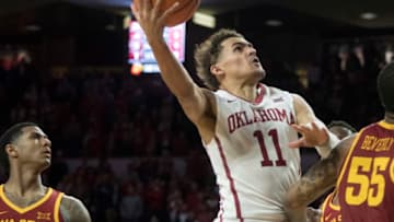 NORMAN, OK - MARCH 2: Oklahoma Sooners guard Trae Young #11 shoots over an Iowa State player during the second half of a NCAA college basketball game at the Lloyd Noble Center on March 2, 2018 in Norman, Oklahoma. (Photo by J Pat Carter/Getty Images)