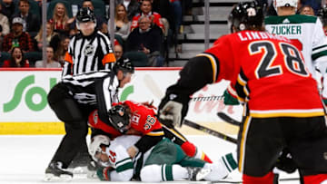 CALGARY, AB - DECEMBER 6: Ryan Lomberg #56 of the Calgary Flames fights Matt Dumba #24 of the Minnesota Wild during an NHL game on December 6, 2018 at the Scotiabank Saddledome in Calgary, Alberta, Canada. (Photo by Gerry Thomas/NHLI via Getty Images)