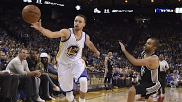 April 7, 2016; Oakland, CA, USA; Golden State Warriors guard Stephen Curry (30) reaches for the basketball against San Antonio Spurs guard Tony Parker (9) during the fourth quarter at Oracle Arena. The Warriors defeated the Spurs 112-101. Mandatory Credit: Kyle Terada-USA TODAY Sports