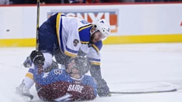 Jan 3, 2016; Denver, CO, USA; St. Louis Blues defenseman Joel Edmundson (6) checks Colorado Avalanche defenseman Tyson Barrie (4) into the ice during the second period at Pepsi Center. Mandatory Credit: Chris Humphreys-USA TODAY Sports