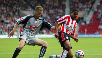 SOUTHAMPTON, UNITED KINGDOM - OCTOBER 29: Theo Walcott of Southampton holds off Andy Wilkinson of Stoke City during the Coca-Cola Championship match between Southampton and Stoke City at St Mary's Stadium on October 29, 2005 in Southampton, England. (Photo by Julian Finney/Getty Images)
