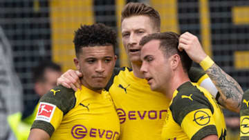 21 April 2019, Baden-Wuerttemberg, Freiburg im Breisgau: Soccer: Bundesliga, SC Freiburg - Borussia Dortmund, 30th matchday in the Black Forest Stadium. The Dortmund scorers Jadon Sancho (l-r), Marco Reus and Mario Götze are happy after his goal to 0:3. Photo: Sebastian Gollnow/dpa - IMPORTANT NOTE: In accordance with the requirements of the DFL Deutsche Fußball Liga or the DFB Deutscher Fußball-Bund, it is prohibited to use or have used photographs taken in the stadium and/or the match in the form of sequence images and/or video-like photo sequences. (Photo by Sebastian Gollnow/picture alliance via Getty Images)