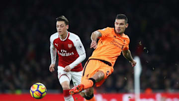 LONDON, ENGLAND - DECEMBER 22: Dejan Lovren of Liverpool clears the ball from Mesut Ozil of Arsenal during the Premier League match between Arsenal and Liverpool at Emirates Stadium on December 22, 2017 in London, England. (Photo by Julian Finney/Getty Images)