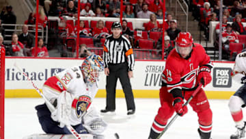 RALEIGH, NC - DECEMBER 2: Justin Williams #14 of the Carolina Hurricanes tries to flip the puck past James Reimer #34 of the Florida Panthers during an NHL game on December 2, 2017 at PNC Arena in Raleigh, North Carolina. (Photo by Gregg Forwerck/NHLI via Getty Images)