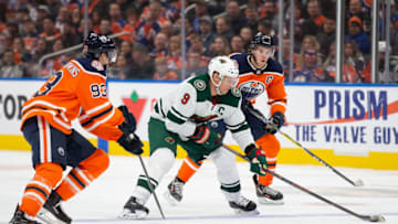 EDMONTON, AB - OCTOBER 30: Ryan Nugent-Hopkins #93 and Connor McDavid #97 of the Edmonton Oilers harass Mikko Koivu #9 of the Minnesota Wild at Rogers Place on October 30, 2018 in Edmonton, Alberta, Canada. (Photo by Codie McLachlan/Getty Images)