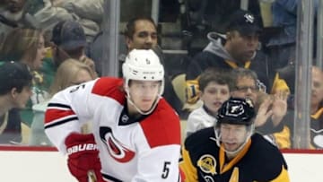 Mar 17, 2016; Pittsburgh, PA, USA; Carolina Hurricanes defenseman Noah Hanifin (5) skates with the puck as Pittsburgh Penguins center Matt Cullen (7) chases during the second period at the CONSOL Energy Center. Mandatory Credit: Charles LeClaire-USA TODAY Sports