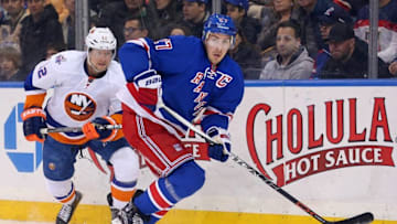 Mar 6, 2016; New York, NY, USA; New York Rangers defenseman Ryan McDonagh (27) plays the puck in front of New York Islanders left wing Josh Bailey (12) during the third period at Madison Square Garden. The Islanders defeated the Rangers 6-4. Mandatory Credit: Brad Penner-USA TODAY Sports