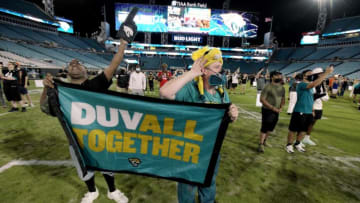 Rodney Poole and his husband Bryen Olive listen as the Jaguars announce their selection of Clemson running back Travis Etienne as their 25th pick of the first round of the NFL Draft late Thursday night, April 29, 2021. The Jacksonville Jaguars held a draft night party at TIAA Bank Field in anticipation of taking former Clemson quarterback Trevor Lawrence with the first pick of the first round of the NFL draft overseen by the Jaguars' new head coach Urban Meyer.Jki 042921 Jagsdraft 22