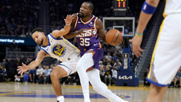SAN FRANCISCO, CALIFORNIA - OCTOBER 24: Kevin Durant #35 of the Phoenix Suns drives on Stephen Curry #30 of the Golden State Warriors during the first quarter at Chase Center on October 24, 2023 in San Francisco, California. NOTE TO USER: User expressly acknowledges and agrees that, by downloading and or using this photograph, User is consenting to the terms and conditions of the Getty Images License Agreement. (Photo by Thearon W. Henderson/Getty Images)
