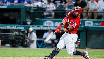 ARLINGTON, TX - JULY 4: Rougned Odor #12 of the Texas Rangers makes contact for a two-run home run during the fourth inning of a baseball game against the Los Angeles Angels of Anaheim at Globe Life Park in Arlington on July 4, 2019 in Arlington, Texas. (Photo by Brandon Wade/Getty Images)