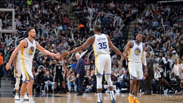 SAN ANTONIO, TX - NOVEMBER 18: Kevin Durant #35 of the Golden State Warriors high fives Klay Thompson #11 of the Golden State Warriors and Kevon Looney #5 of the Golden State Warriors on November 18, 2018 at the AT&T Center in San Antonio, Texas. NOTE TO USER: User expressly acknowledges and agrees that, by downloading and or using this photograph, user is consenting to the terms and conditions of the Getty Images License Agreement. Mandatory Copyright Notice: Copyright 2018 NBAE (Photos by Mark Sobhani/NBAE via Getty Images)