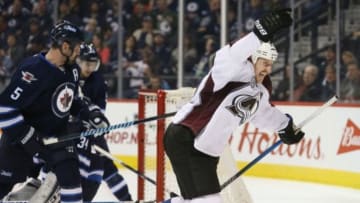 Nov 23, 2015; Winnipeg, Manitoba, CAN; Colorado Avalanche left wing Cody McLeod (55) puts the puck past Winnipeg Jets goalie Michael Hutchinson (34) during the third period at MTS Centre. Colorado wins 4-1. Mandatory Credit: Bruce Fedyck-USA TODAY Sports