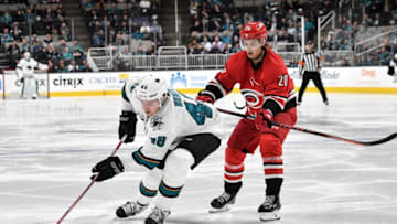 SAN JOSE, CA - DECEMBER 05: Tomas Hertl #48 of the San Jose Sharks skates with the puck against Sebastian Aho #20 of the Carolina Hurricanes at SAP Center on December 5, 2018 in San Jose, California (Photo by Brandon Magnus/NHLI via Getty Images)