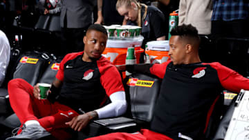 PORTLAND, OR - OCTOBER 7: Damian Lillard #0, CJ McCollum #3 of the Portland Trail Blazers talk on the bench against the Utah Jazz during a pre-season game on October 7, 2018 at the Moda Center in Portland, Oregon. NOTE TO USER: User expressly acknowledges and agrees that, by downloading and or using this Photograph, user is consenting to the terms and conditions of the Getty Images License Agreement. Mandatory Copyright Notice: Copyright 2018 NBAE (Photo by Sam Forencich/NBAE via Getty Images)