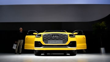 HANOVER, GERMANY - JUNE 22: A visitor walks by an Audi Q2 quattro during the annual Volkswagen general shareholders meeting on June 22, 2016 in Hanover, Germany. The meeting is taking place as Volkswagen continues to grapple with the consequences of revelations it used cheating software to manipulate the emissions of its diesel cars. Mueller himself recently expressed concern that the future of diesel cars may be doomed due to the scandal. Meanwhile German state prosecutors have launched an investigation into former VW head Martin Winterkorn over charges he withheld information about the growing scandal in order to influence financial markets. (Photo by Alexander Koerner/Getty Images)