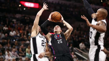 Mar 15, 2016; San Antonio, TX, USA; Los Angeles Clippers point guard Austin Rivers (25) drives to the basket as San Antonio Spurs guard Kevin Martin (23) and power forward David West (30, right) defend during the second half at AT&T Center. Mandatory Credit: Soobum Im-USA TODAY Sports