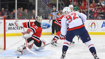 Mar 25, 2016; Newark, NJ, USA; Washington Capitals center Evgeny Kuznetsov (92) shoots the puck against New Jersey Devils goalie Scott Wedgewood (31) during the first period at Prudential Center. Mandatory Credit: Ed Mulholland-USA TODAY Sports