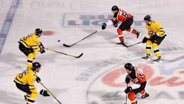 STATELINE, NEVADA - FEBRUARY 21: Nicolas Aube-Kubel #62 of the Philadelphia Flyers skates with the puck past Charlie Coyle #13 of the Boston Bruins during the 'NHL Outdoors At Lake Tahoe' at the Edgewood Tahoe Resort on February 21, 2021 in Stateline, Nevada. The Bruins defeated the Flyers 7-3. (Photo by Christian Petersen/Getty Images)