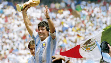 MEXICO CITY, MEXICO - JUNE 29: Diego Maradona of Argentina holds the World Cup trophy after defeating West Germany 3-2 during the 1986 FIFA World Cup Final match at the Azteca Stadium on June 29, 1986 in Mexico City, Mexico. (Photo by Archivo El Grafico/Getty Images)