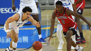 LOS ANGELES, CA - FEBRUARY 18: Jules Bernard #1 of the UCLA Bruins and Bennedict Mathurin #0 of the Arizona Wildcats chase down a loose ball in the second half of the game at Pauley Pavilion on February 18, 2021 in Los Angeles, California. (Photo by Jayne Kamin-Oncea/Getty Images)