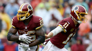 LANDOVER, MD - SEPTEMBER 23: Quarterback Alex Smith #11 hands the ball off to Adrian Peterson #26 of the Washington Redskins against the Green Bay Packeer at FedExField on September 23, 2018 in Landover, Maryland. (Photo by Rob Carr/Getty Images)