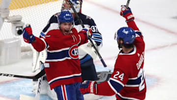 Jun 7, 2021; Montreal, Quebec, CAN; Montreal Canadiens left wing Artturi Lehkonen (62) celebrates his goal against Winnipeg Jets goaltender Connor Hellebuyck (37) with teammate left wing Phillip Danault (24) during the first period in game four of the second round of the 2021 Stanley Cup Playoffs at Bell Centre. Mandatory Credit: Jean-Yves Ahern-USA TODAY Sports